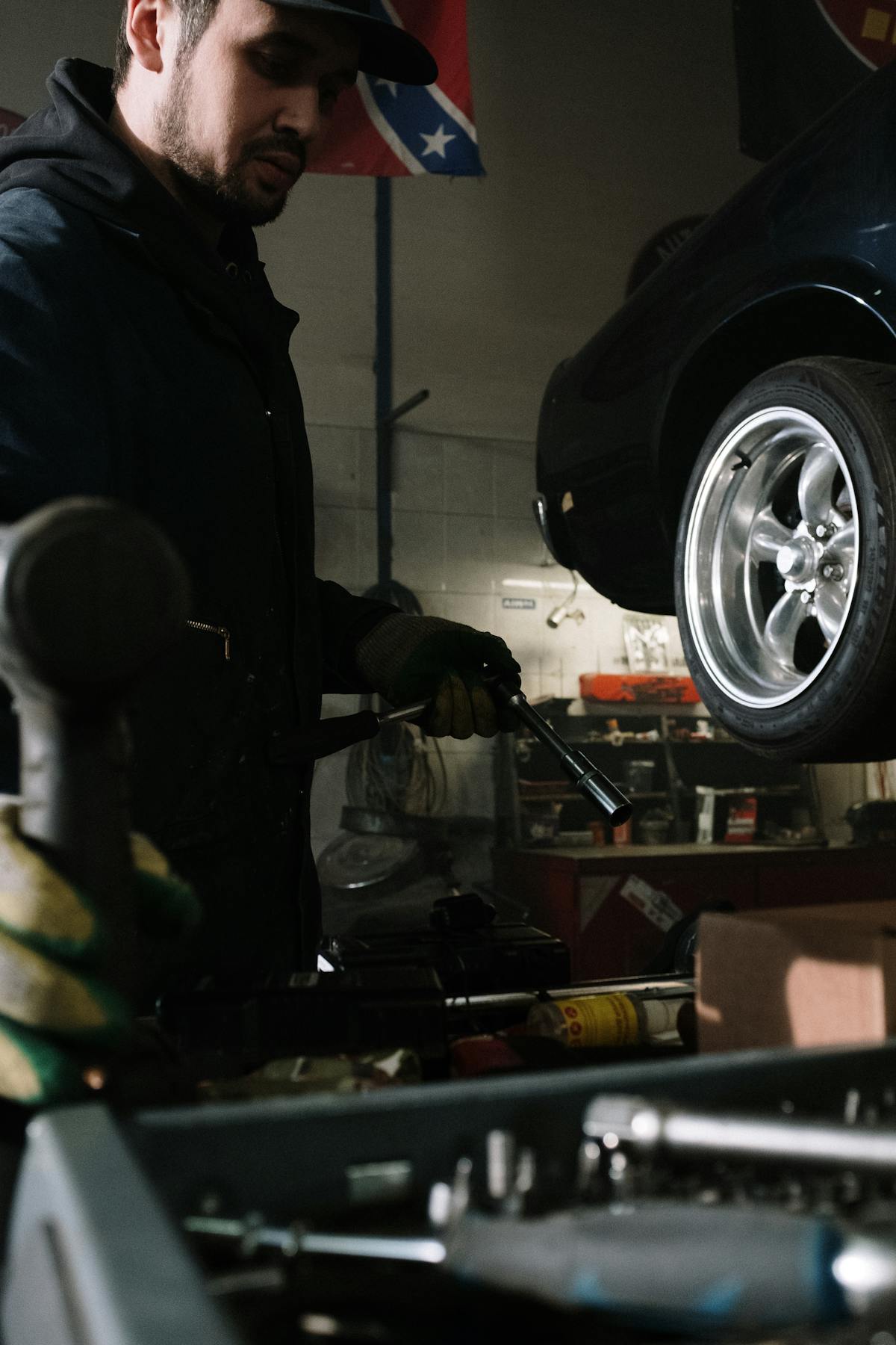 Service advisor explaining repairs beside vehicle lift